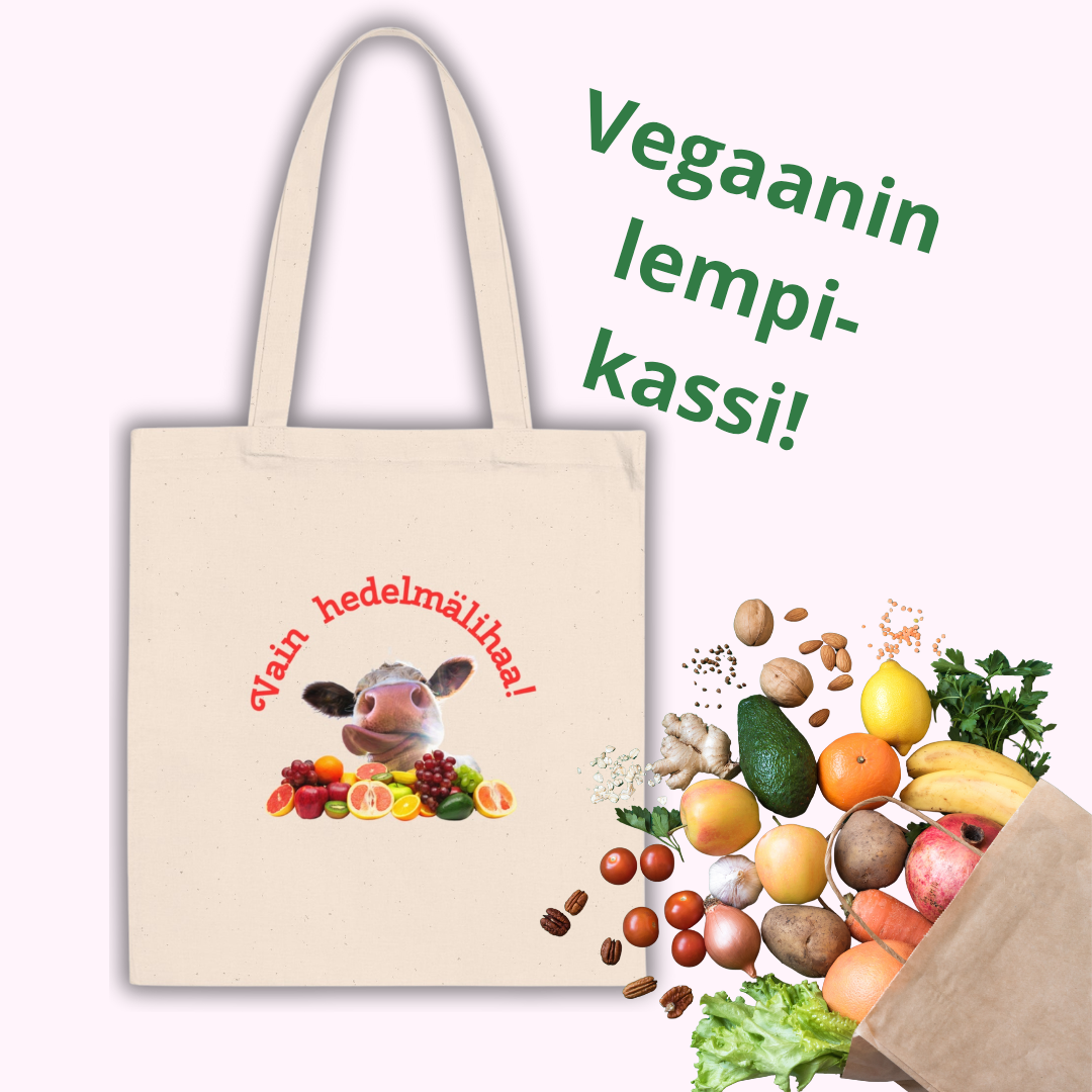 Kuvassaluonnonvalkoinen kassi, jossa kuva lehmästä ja hedelmistä, ja kuvan yläpuolella kaareva teksti, jossalukee Vain hedelmälihaa! 